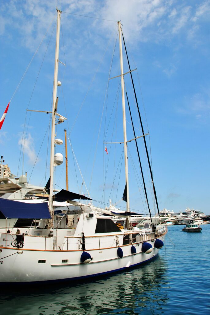 Explore luxurious yachts docked in Monaco's stunning marina on a bright, sunny day.